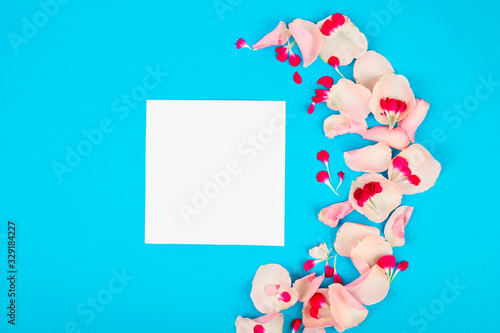 Blank frame mockup with pink petals. Beautiful floral pattern. Flat lay style