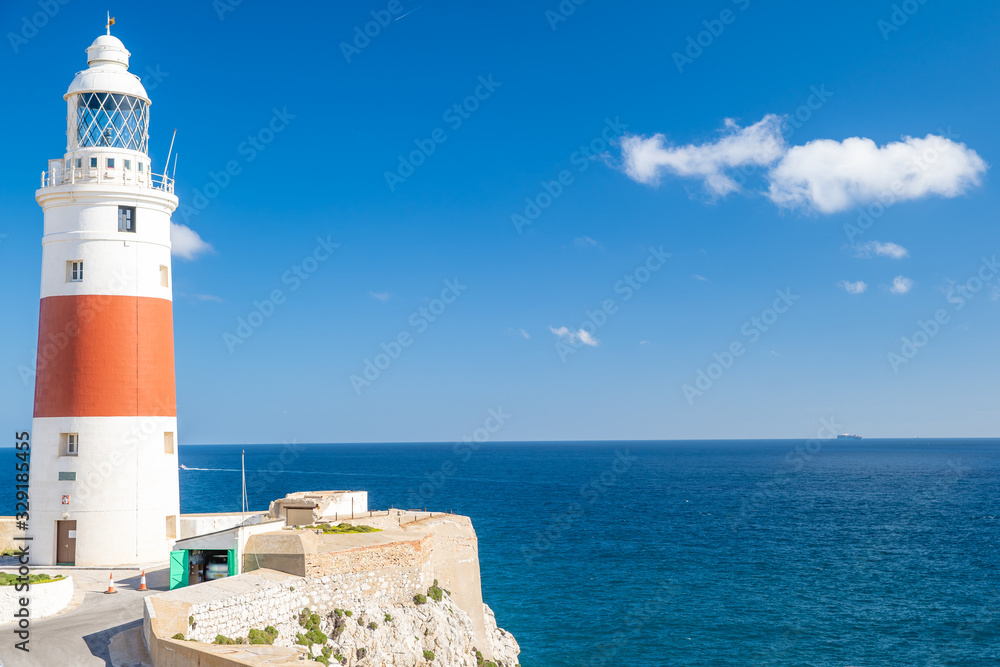 a lighthouse on the coast of the ocean serves to indicate the direction of lost ships