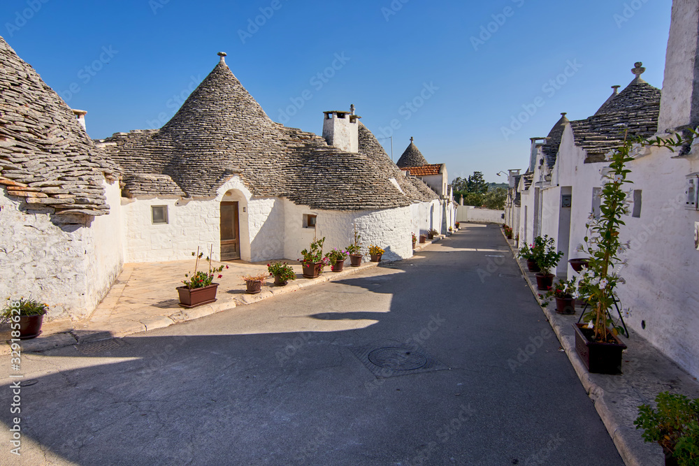 Typical Picturesque Street Displaying The Traditional Trulli houses in Alberobello city, Apulia, Italy