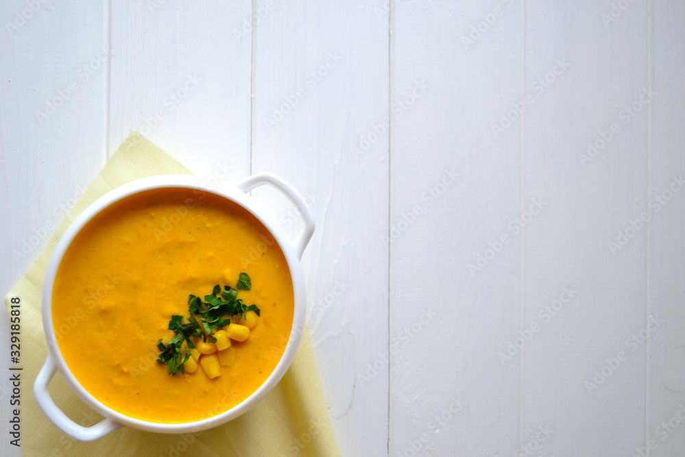 Corn soup with parsley and bread on a white background Corn soup with parsley and bread on a white background