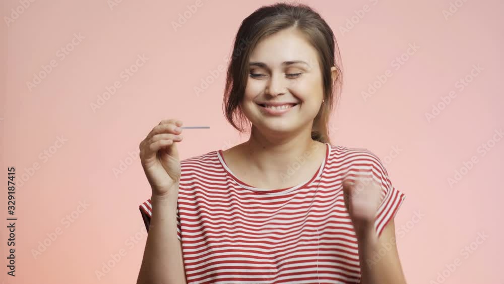 young woman checking result of a medical pregnancy test, girl experienced relief and jumping with happiness test is negative, family planning concept young woman checking result of a medical pregnancy test, girl experienced relief and jumping with happiness test is negative, family planning concept