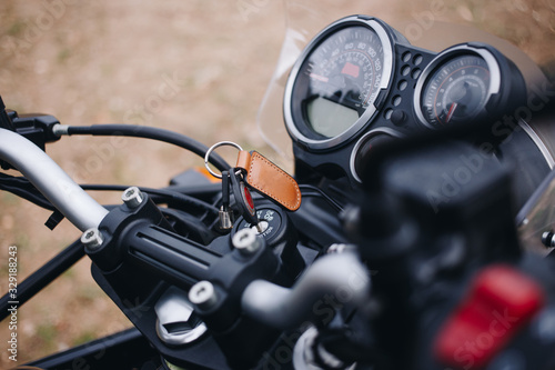 Close up behind shoulder shot of motorcycle handlebar. Speedometer and powermeter computers on handlebar. Touring or adventure off road motorcycle