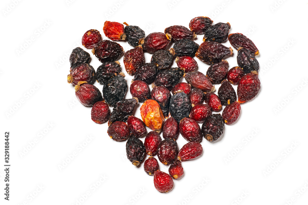 Dried rosehip laid out in the shape of a heart on a white background. Natural source of vimtamin C Dried rosehip laid out in the shape of a heart on a white background. Natural source of vimtamin C