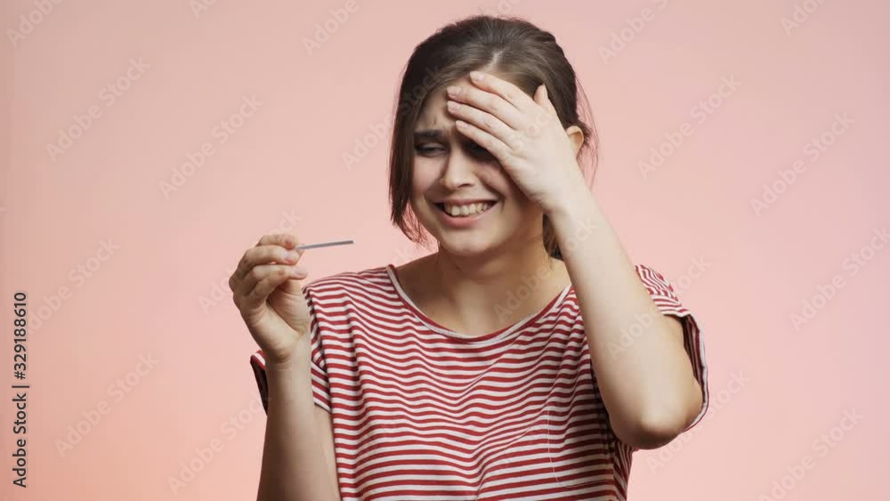 young woman checking result of a medical pregnancy test, girl experienced relief and happiness test is negative, family planning concept young woman checking result of a medical pregnancy test, girl experienced relief and happiness test is negative, family planning concept