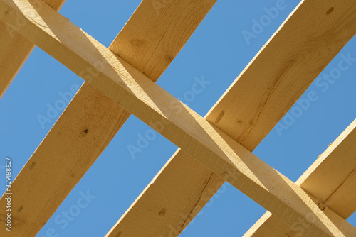 Wood board assembled on construction site. New frame structure of building. Scaffolding framework made from natural materials. Wooden floor or ceiling. Elements and components of the construction.