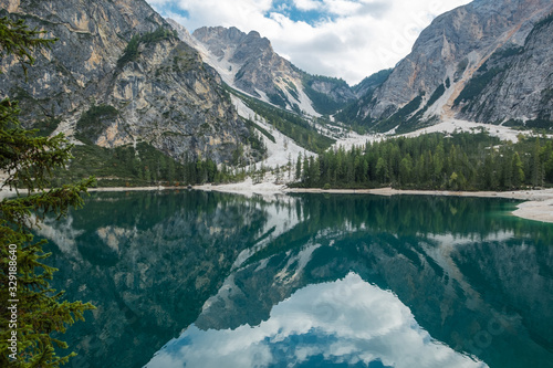 Emerald and turquoise waters of Lake Braies reflect surrounding mountains © Annee