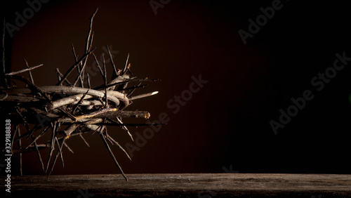 Fotografie Dramatic image of crown of thorns against dark red background as symbol of death