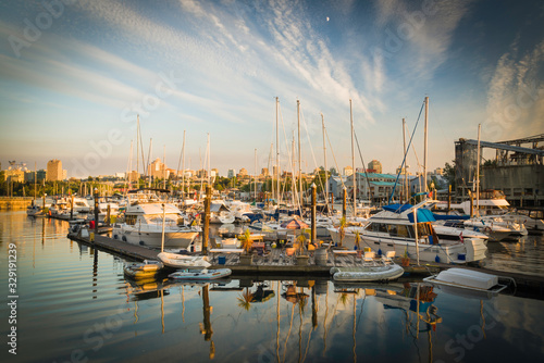 Ocean going craft of all description await their next voyage under a sunset sky in a small marina on False Creek, Vancouver, British Columbia. © Mark Baldwin