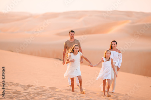 Photography People among dunes in desert in United Arab Emirates