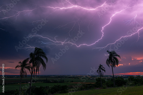 An electrical  storm passes behind the city of Bundaberg