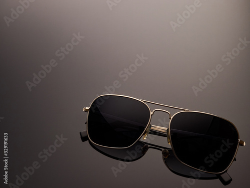Stylish polarized mirrored almost round sunglasses with metal frame and folded ear arms. Logos removed.