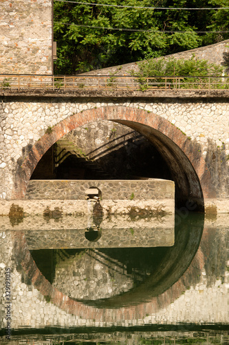 Detail of arched stonework along the banks of the Serchio river photo