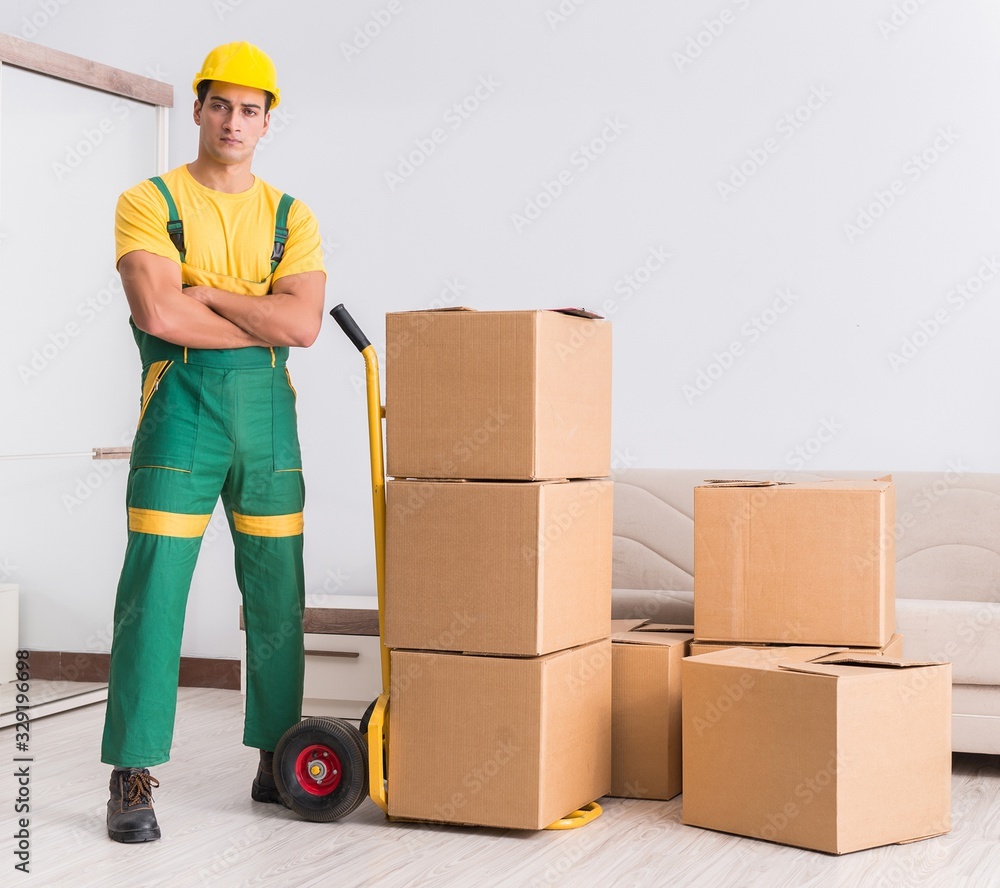 Transportation worker delivering boxes to house Transportation worker delivering boxes to house