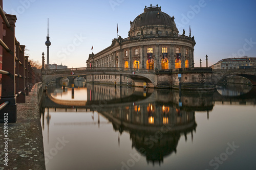Berlin, Germany, Museum Island on Spree river and TV tower in the background at sunrise, Bode-Museum, cityscape early in the morning, reflections in the water