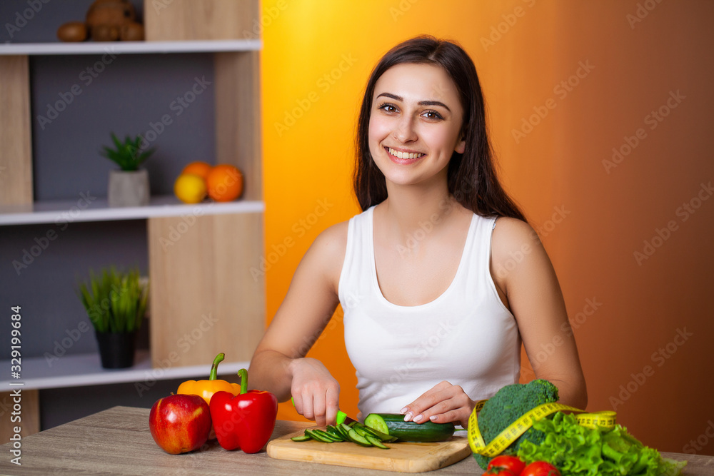 Young beautiful girl prepares a useful diet salad Young beautiful girl prepares a useful diet salad