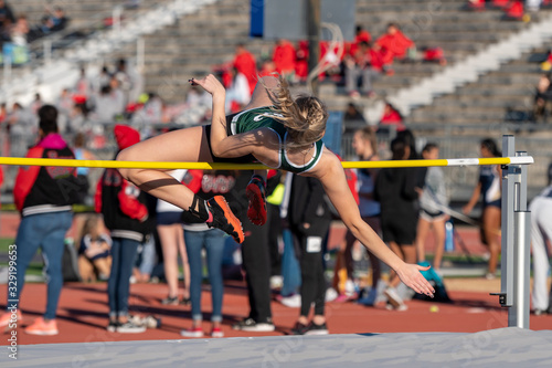 Young girl competing in the High Jump at a track meet photo