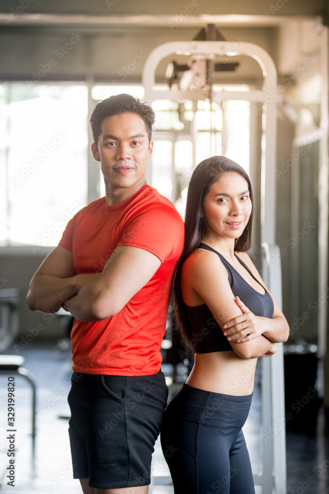 The interesting male trainer teaches how to give dumbbells to attractive women and smiley faces in the gym. The interesting male trainer teaches how to give dumbbells to attractive women and smiley faces in the gym.