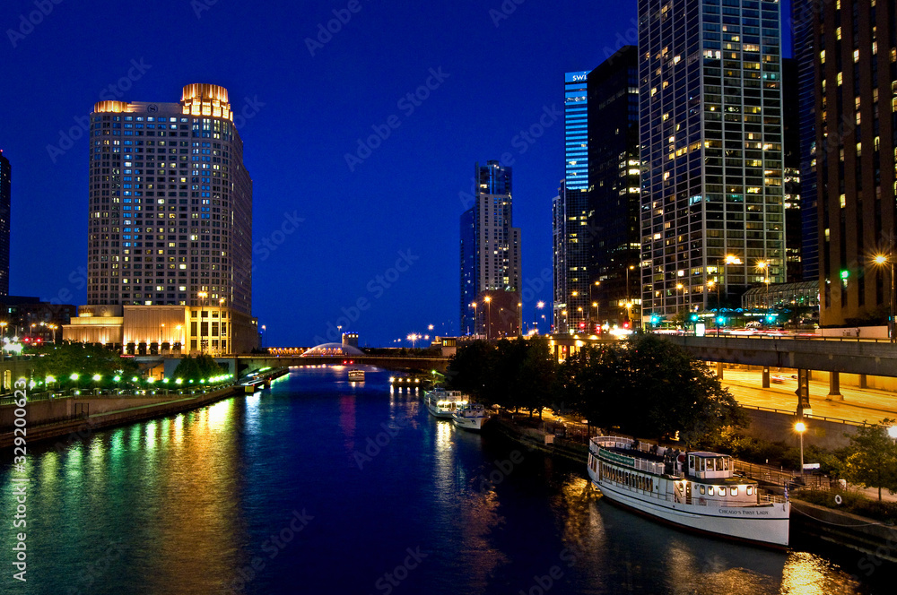 Nighttime reflections of the Chicago city skyline in the Chicago River.