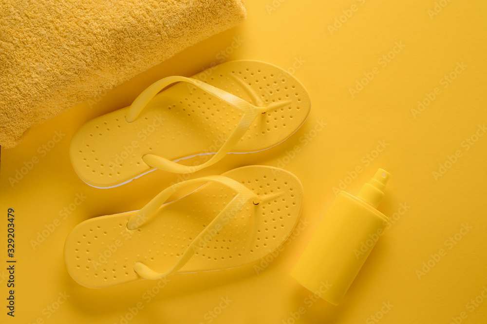 Towel, sandals and sunscreen spray Towel, sandals and sunscreen spray