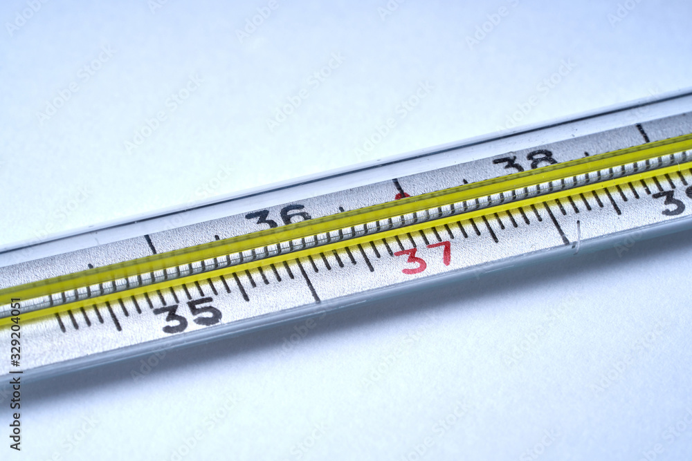 Thermometer for measuring temperature on a white background with texture. Thermometer for measuring temperature on a white background with texture.