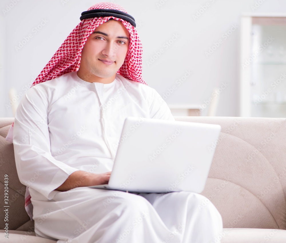 Young arab businessman working with laptop on sofa Young arab businessman working with laptop on sofa
