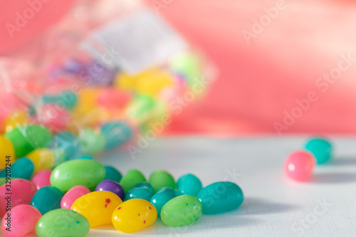Colourful candies spilled across a white surface