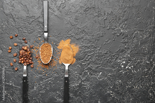 Spoons with different types of coffee on grey background