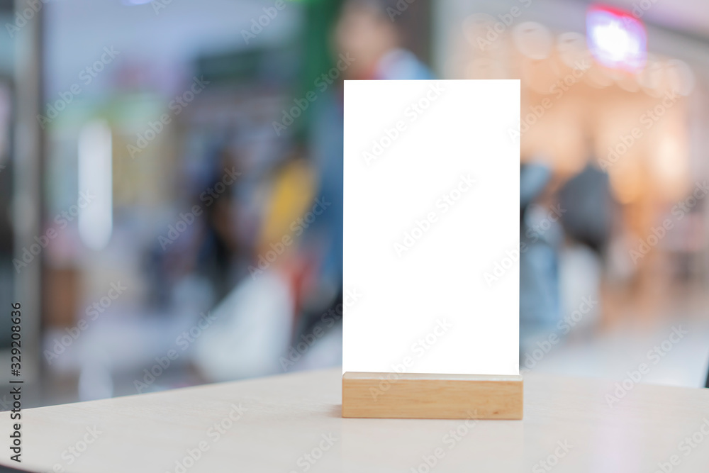 Mock up Label the blank menu frame in Bar restaurant ,Stand for booklets with white sheets paper acrylic tent card on wooden table cafeteria blurred background can inserting the text of the customer. Mock up Label the blank menu frame in Bar restaurant ,Stand for booklets with white sheets paper acrylic tent card on wooden table cafeteria blurred background can inserting the text of the customer.