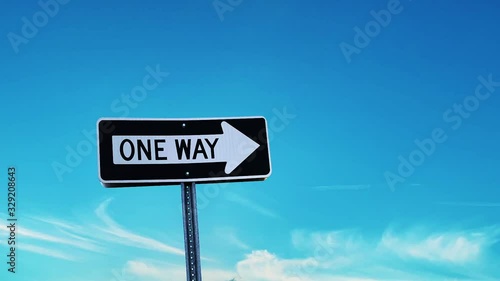 road sign with blue sky and clouds