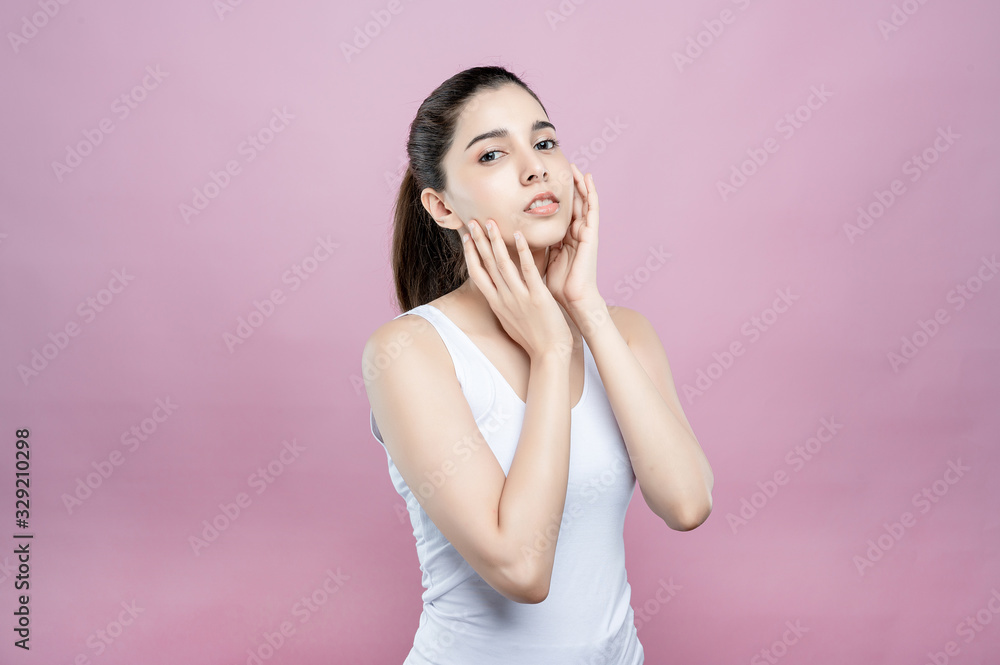 Mix asian caucasian woman confident beauty poses for healthy skin beauty in pink seamless background. Cosmetic, skincare, surgery concept. Her skin and face are beautiful, fresh and youthful. Mix asian caucasian woman confident beauty poses for healthy skin beauty in pink seamless background. Cosmetic, skincare, surgery concept. Her skin and face are beautiful, fresh and youthful.