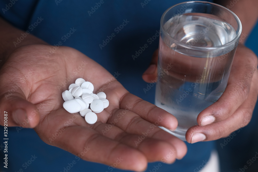 close up of man hand taking pills close up of man hand taking pills