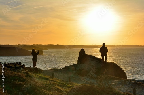 People in front of the sea at sunset. Cancale in Brittany. France photo