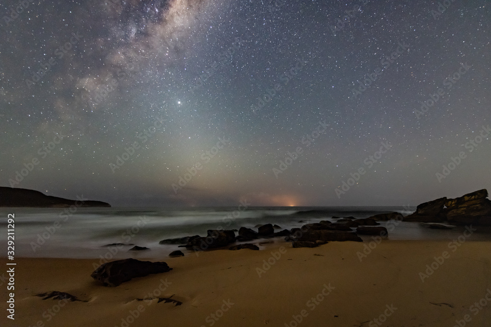 Milky Way Night Sky and Seascape with a Ship on the Horizon - obrazy, fototapety, plakaty 