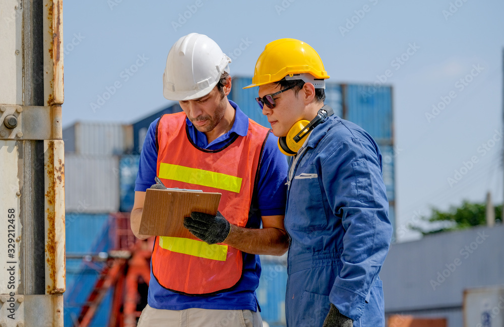 Technician and engineer work together for checking quality and product in cargo container shipping area. Technician and engineer work together for checking quality and product in cargo container shipping area.