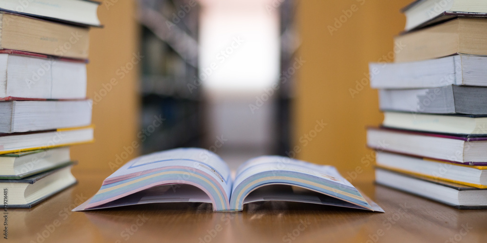 pile of books on wooden table pile of books on wooden table