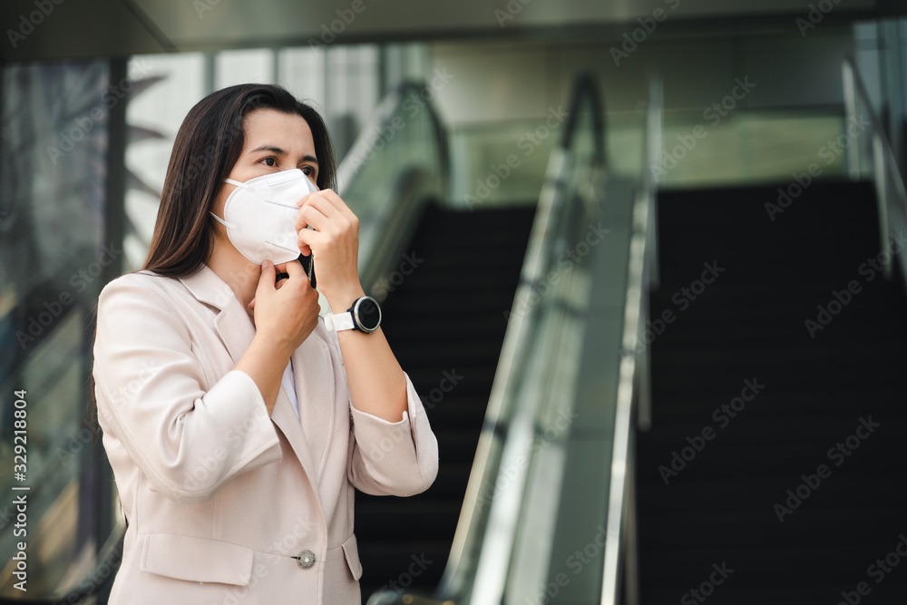 Asian woman wearing N95 mask to protect pollution PM2.5 and virus. COVID-19 Coronavirus and Air pollution pm2.5 concept. Asian woman wearing N95 mask to protect pollution PM2.5 and virus. COVID-19 Coronavirus and Air pollution pm2.5 concept.