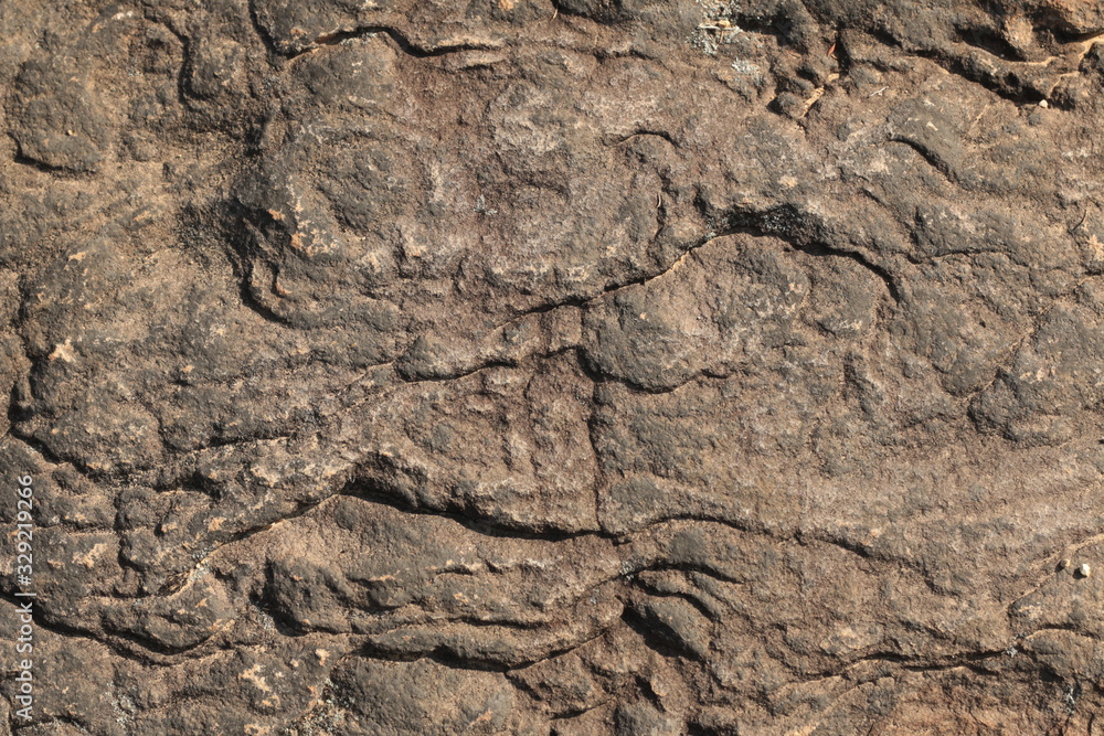 textures and patterns showing the formation of stone from ancient cooled lava flow on rock faces in a volcanic area rural Victoria, Australia.