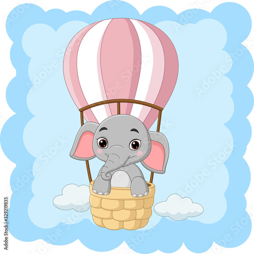 Cartoon baby elephant riding a hot air balloon