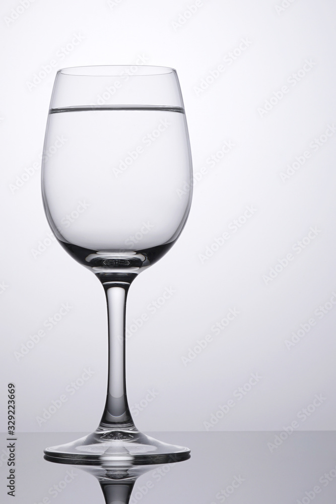 Wine glass with pure water clean isolated on white with space on right for copy Wine glass with pure water clean isolated on white with space on right for copy