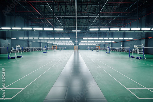 Empty gymnasium with courts for badminton and tennis competitions and training
