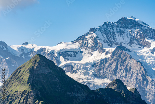 Switzerland, Panoramic view on Eiger, Monch and Jungfraujoch and green Alps around Mannlichen