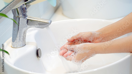 Fotografie Hygiene concept Wash your hands with soap in the sink