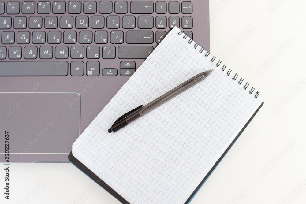 Workplace with laptop, notebook and pen. Business concept Workplace with laptop, notebook and pen. Business concept