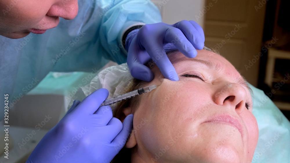 Woman getting cosmetic injection, closeup. Woman in beauty salon. plastic surgery clinic Woman getting cosmetic injection, closeup. Woman in beauty salon. plastic surgery clinic