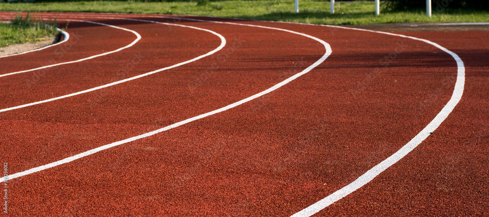 Running track in the stadium. Rubber coating. Treadmill in the fresh air. Healthy lifestyle concept. Athletes cardio workout Running track in the stadium. Rubber coating. Treadmill in the fresh air. Healthy lifestyle concept. Athletes cardio workout