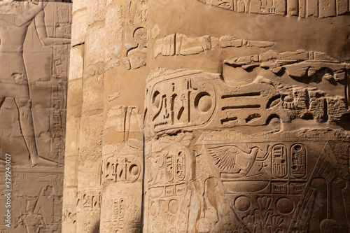 Karnak Temple, complex of Amun-Re. Great Hypostyle Hall. Embossed hieroglyphics on columns and walls. Luxor Governorate, Egypt.