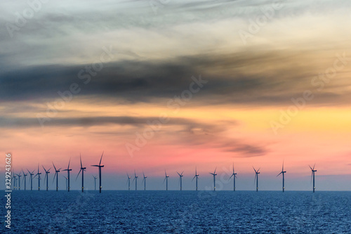 HORNSEA OFFSHORE WIND FARM, UK - 2016 JULY 15. Sunset with orange sky together with the Wind Farm.