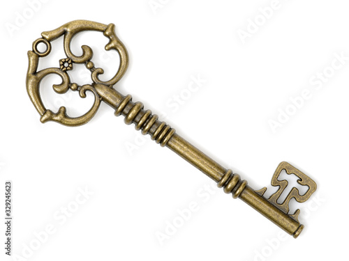 old brass key against a white background