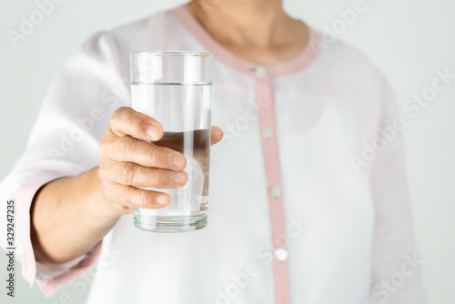 drinking water in the senior woman's hand, Concept of environment protection, healthy drink.