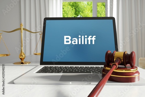 Bailiff – Law, Judgment, Web. Laptop in the office with term on the screen. Hammer, Libra, Lawyer. photo